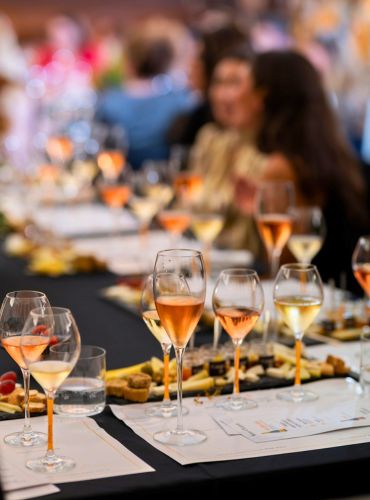 Corporate Greek wine tasting setup with glasses and tasting notes