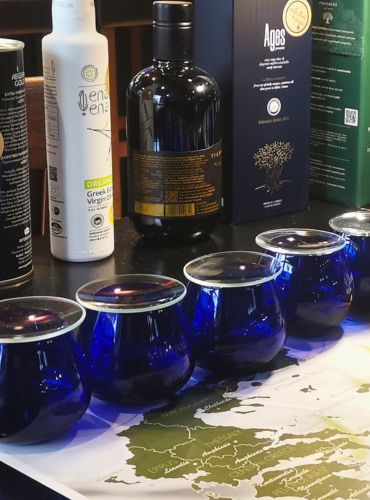 Greek olive oil tasting at Casa Cinque with blue tasting glasses